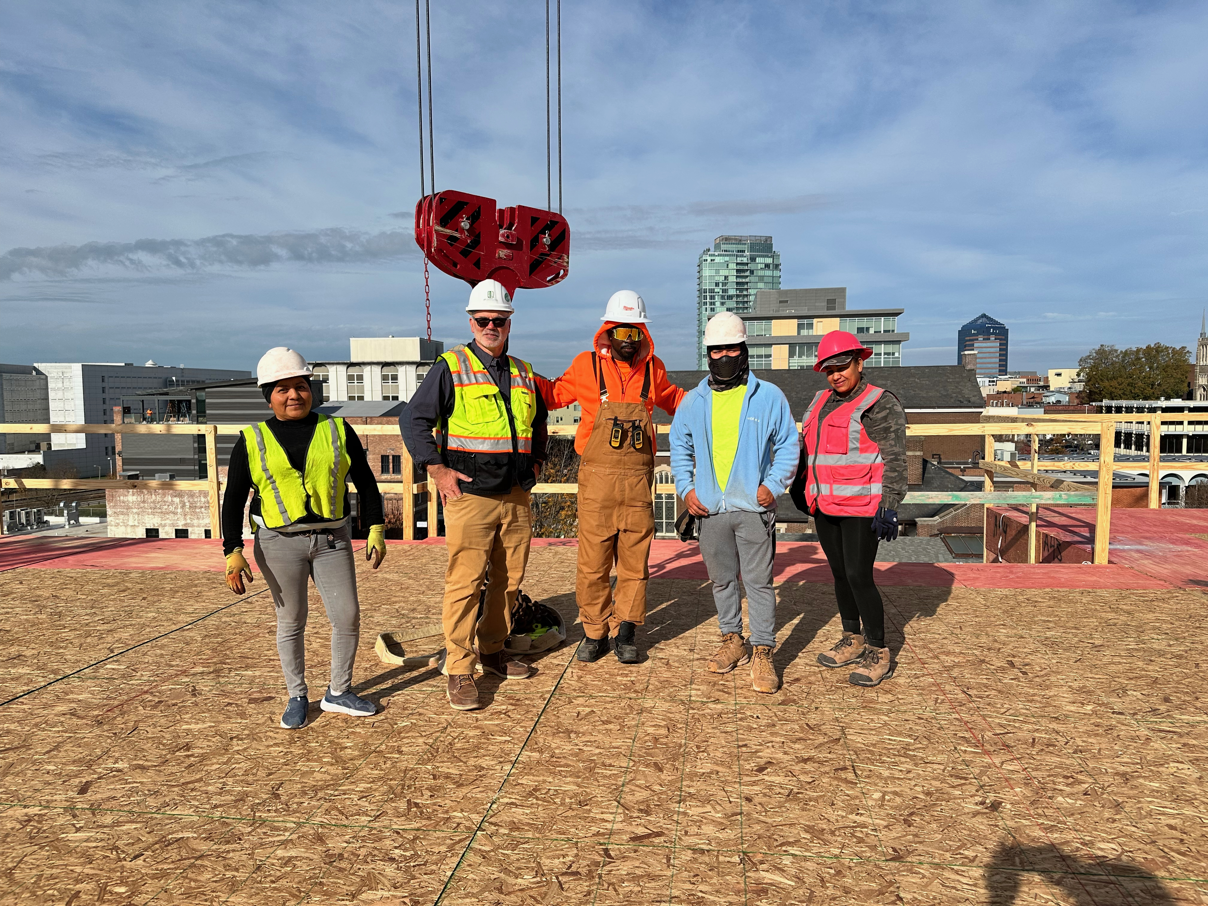 Bruce with a construction crew on a rooftop