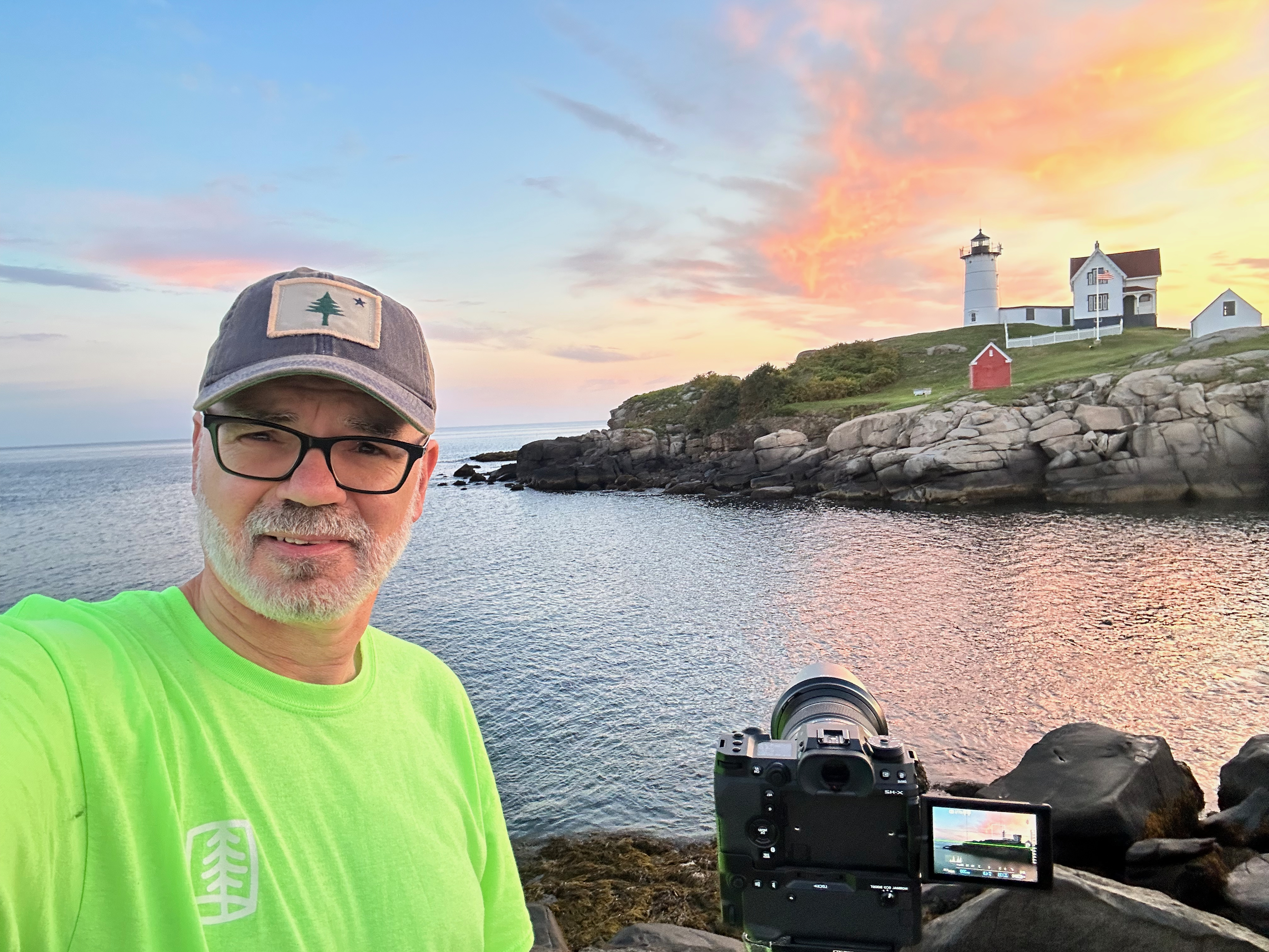 Bruce photographing at sunrise by the lighthouse