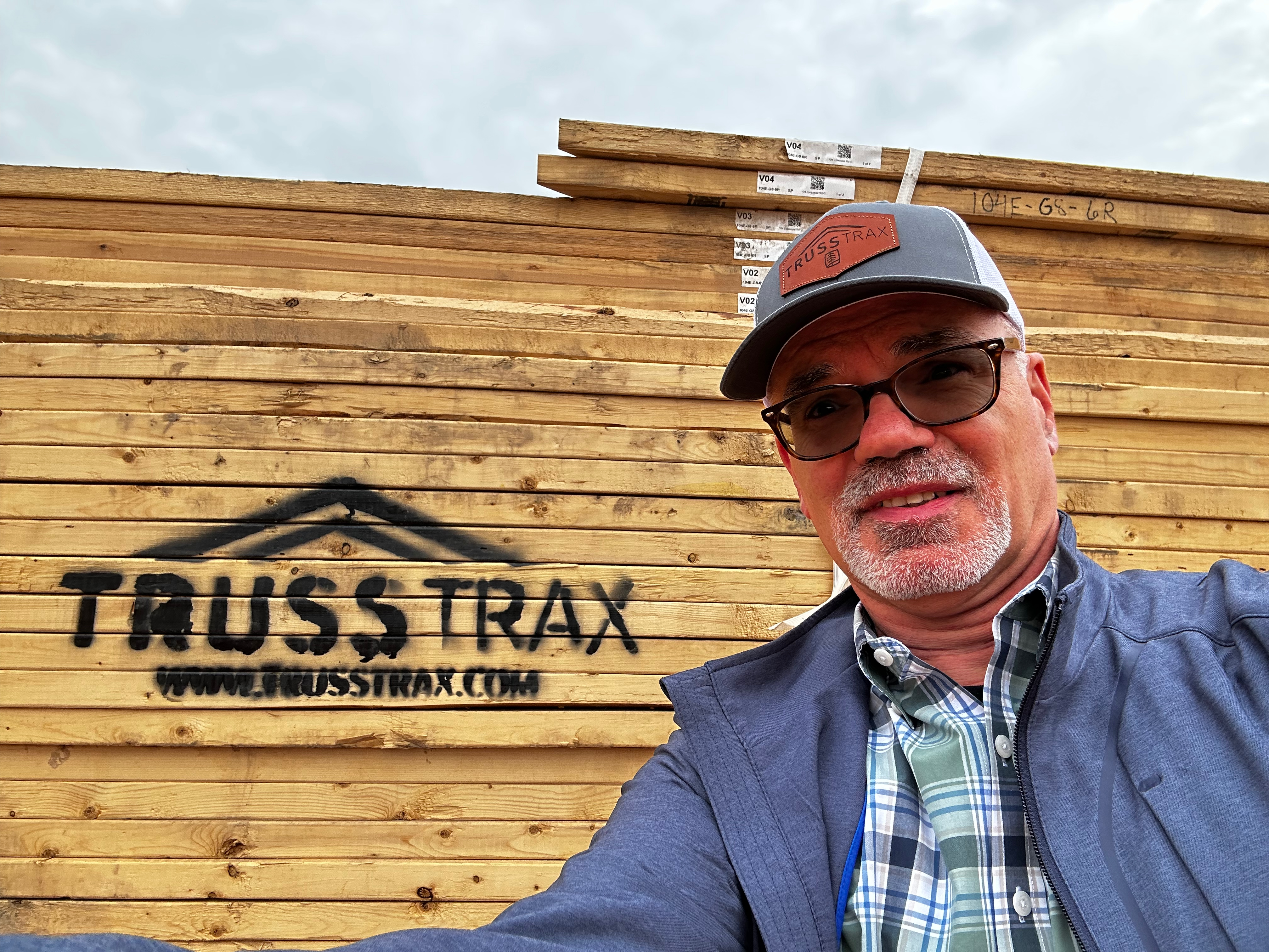 Bruce in front of a TrussTrax lumber stack