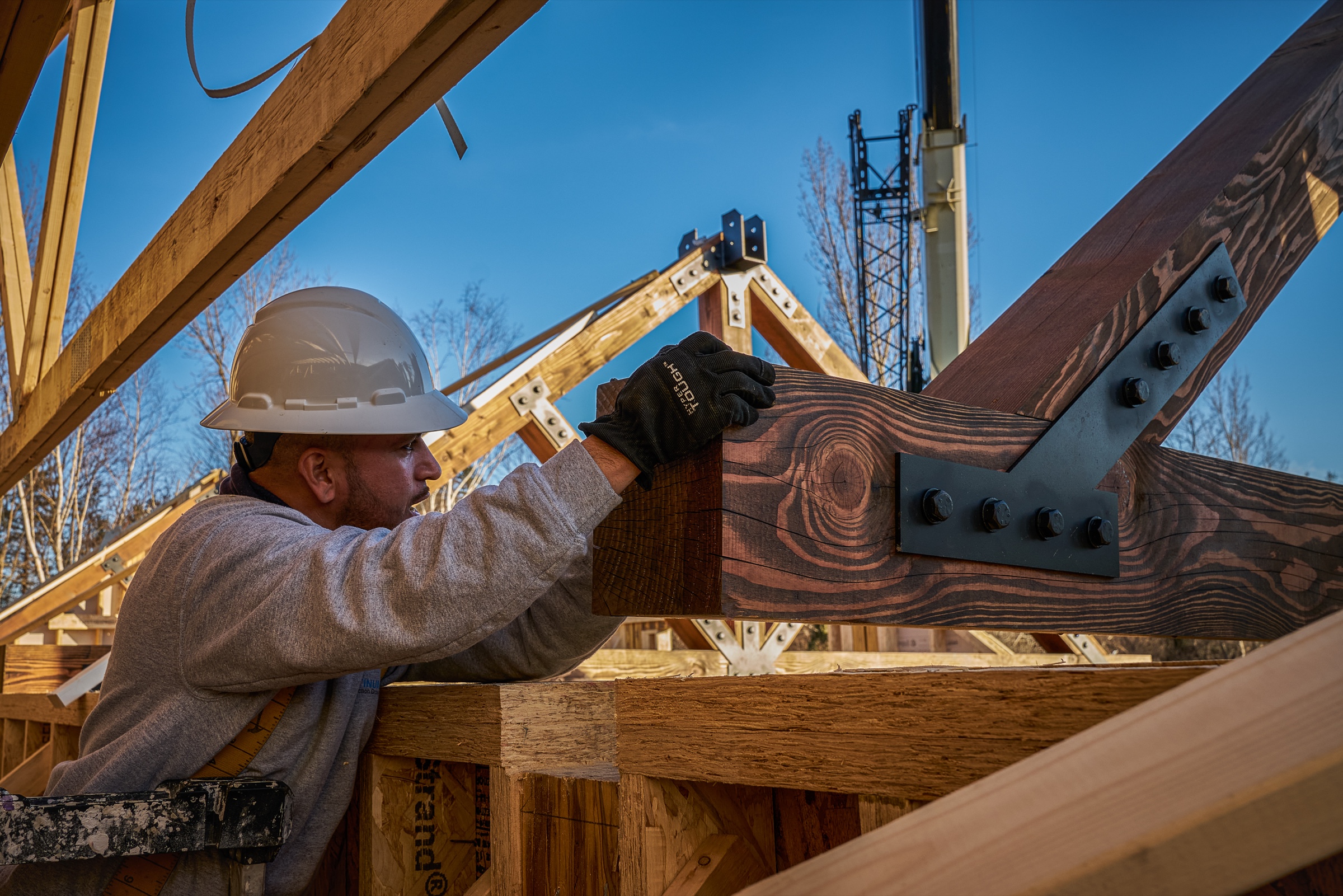 Timber truss being set into place, Lee Massachusetts — construction photography by Bruce Peter Morin